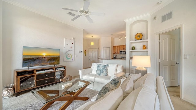 8397 38th Street Cir E Unit 306, Sarasota, FL 34243 - living area with light colored carpet, a ceiling fan, ornamental molding, and built in features