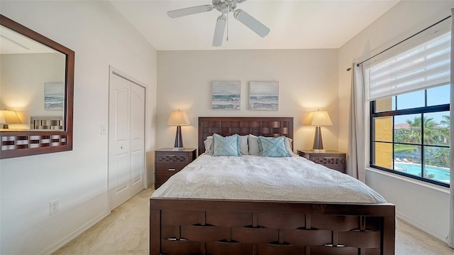 8397 38th Street Cir E Unit 306, Sarasota, FL 34243 - bedroom with light carpet, ceiling fan, and a closet
