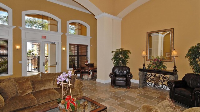8397 38th Street Cir E Unit 306, Sarasota, FL 34243 - living area with stone tile flooring, a high ceiling, ornamental molding, and french doors