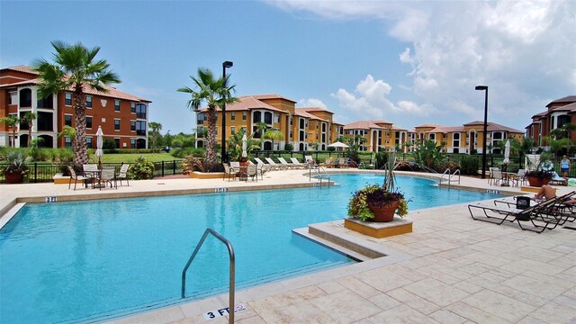 8397 38th Street Cir E Unit 306, Sarasota, FL 34243 - community pool with a patio area and a residential view