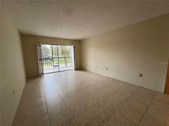 3231 Beneva Rd Unit 202, Sarasota, FL 34232 - spare room featuring tile patterned flooring and a textured ceiling