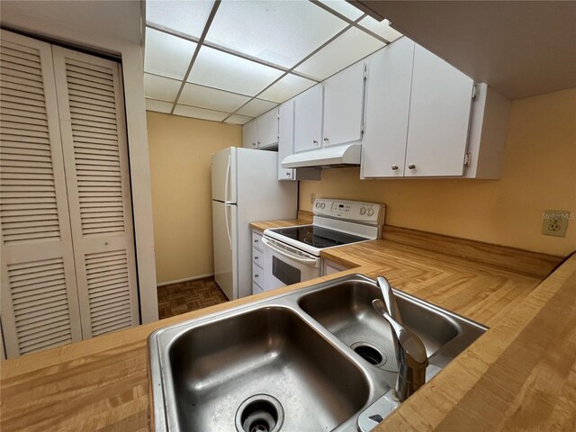 3231 Beneva Rd Unit 202, Sarasota, FL 34232 - kitchen featuring white appliances, under cabinet range hood, butcher block countertops, white cabinetry, and a paneled ceiling