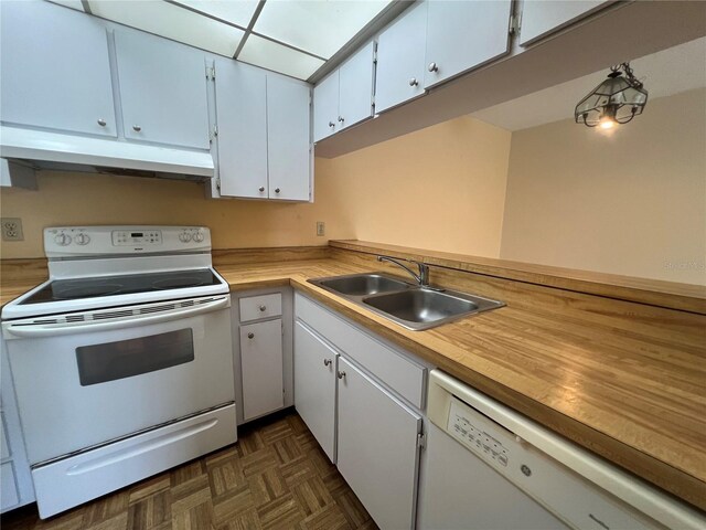 3231 Beneva Rd Unit 202, Sarasota, FL 34232 - kitchen featuring white appliances, under cabinet range hood, light countertops, and white cabinets