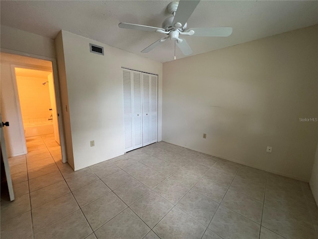 3231 Beneva Rd Unit 202, Sarasota, FL 34232 - unfurnished bedroom with light tile patterned flooring, a closet, and ceiling fan