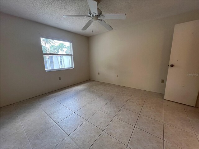 3231 Beneva Rd Unit 202, Sarasota, FL 34232 - unfurnished room with light tile patterned floors, ceiling fan, and a textured ceiling