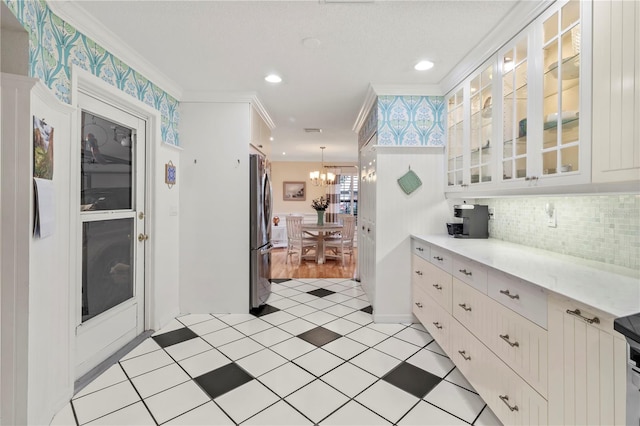 6818 Arbor Oaks Cir, Bradenton, FL 34209 - kitchen with freestanding refrigerator, ornamental molding, white cabinetry, a chandelier, and recessed lighting