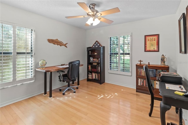 6818 Arbor Oaks Cir, Bradenton, FL 34209 - office with light wood finished floors, a ceiling fan, and a textured ceiling