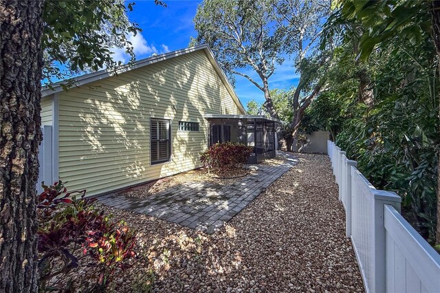 6818 Arbor Oaks Cir, Bradenton, FL 34209 - view of home's exterior featuring a sunroom, a fenced backyard, and a patio