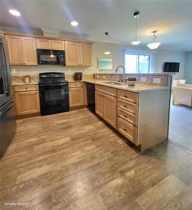 1106 49th Avenue Dr W, Bradenton, FL 34207 - kitchen with black appliances, a peninsula, crown molding, hanging light fixtures, and light wood-style flooring