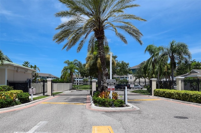 4802 51st St W Unit 1310, Bradenton, FL 34210 - view of asphalt street featuring a gate, a gated entry, a residential view, and curbs
