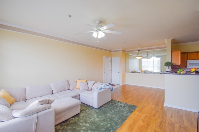 4802 51st St W Unit 1310, Bradenton, FL 34210 - living room featuring light wood finished floors, ceiling fan, and ornamental molding