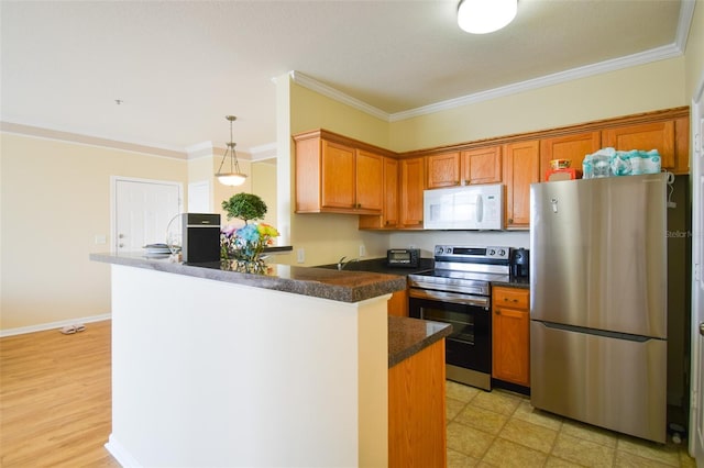 4802 51st St W Unit 1310, Bradenton, FL 34210 - kitchen featuring appliances with stainless steel finishes, dark countertops, a peninsula, brown cabinets, and crown molding