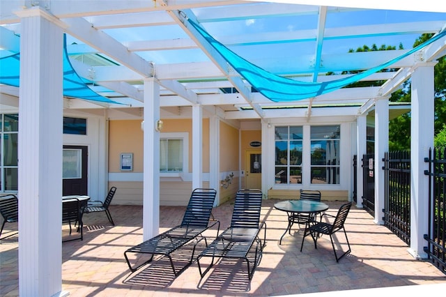4802 51st St W Unit 1310, Bradenton, FL 34210 - view of patio / terrace featuring a pergola and outdoor dining space
