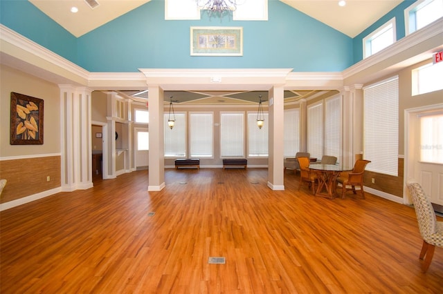 4802 51st St W Unit 1310, Bradenton, FL 34210 - living area with high vaulted ceiling, a chandelier, ornate columns, and light wood-type flooring