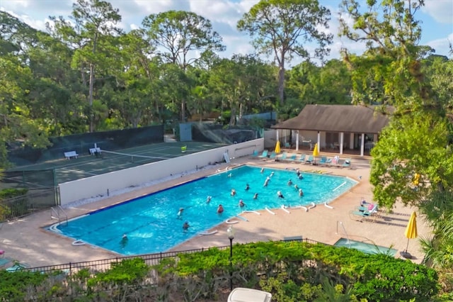 4658 Longwater Chase Unit 104, Sarasota, FL 34235 - community pool with a patio and view of wooded area