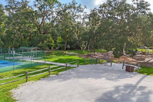 4658 Longwater Chase Unit 104, Sarasota, FL 34235 - surrounding community with view of wooded area and a tennis court