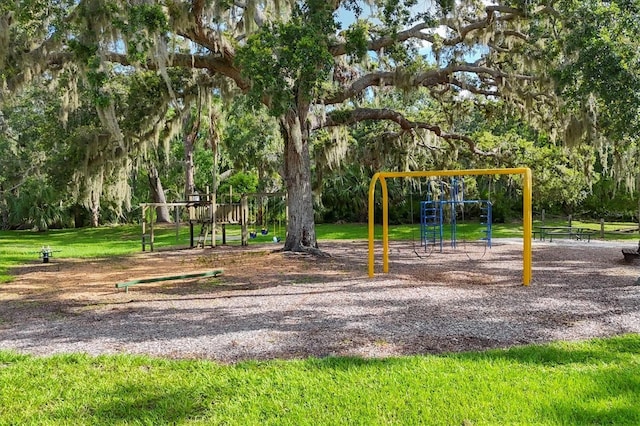 4658 Longwater Chase Unit 104, Sarasota, FL 34235 - community jungle gym featuring a lawn