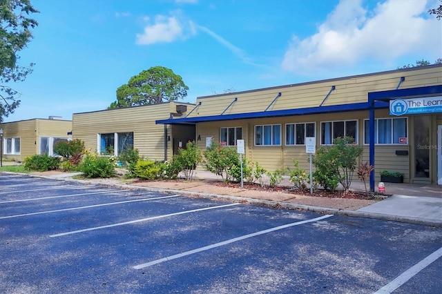 4658 Longwater Chase Unit 104, Sarasota, FL 34235 - view of property featuring uncovered parking