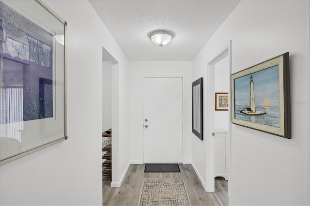 4658 Longwater Chase Unit 104, Sarasota, FL 34235 - foyer with wood finished floors and a textured ceiling
