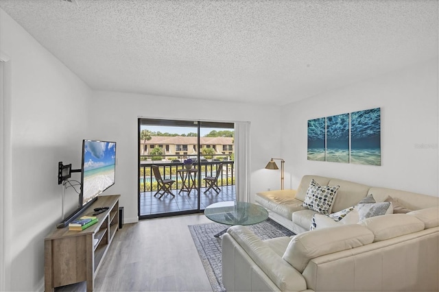 4658 Longwater Chase Unit 104, Sarasota, FL 34235 - living room with a textured ceiling and wood finished floors