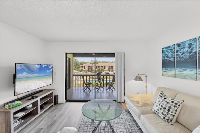 4658 Longwater Chase Unit 104, Sarasota, FL 34235 - living area with wood finished floors and a textured ceiling