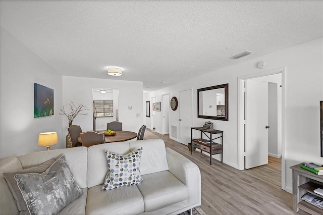 4658 Longwater Chase Unit 104, Sarasota, FL 34235 - living area with light wood-style floors and a textured ceiling