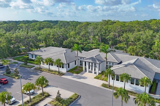 4658 Longwater Chase Unit 104, Sarasota, FL 34235 - view of subject property featuring a heavily wooded area
