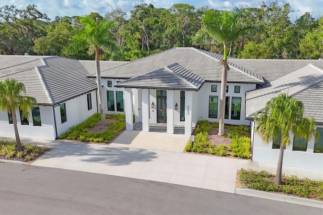 4658 Longwater Chase Unit 104, Sarasota, FL 34235 - view of front of home with stucco siding and a tiled roof
