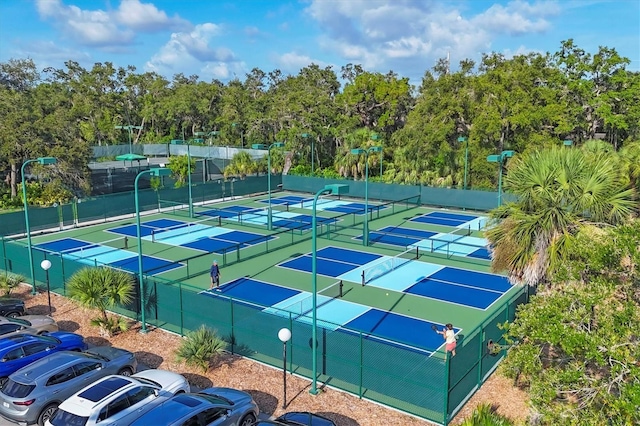 4658 Longwater Chase Unit 104, Sarasota, FL 34235 - view of tennis court with view of wooded area