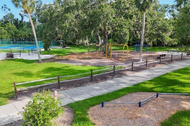 4658 Longwater Chase Unit 104, Sarasota, FL 34235 - view of home's community with a tennis court and view of wooded area