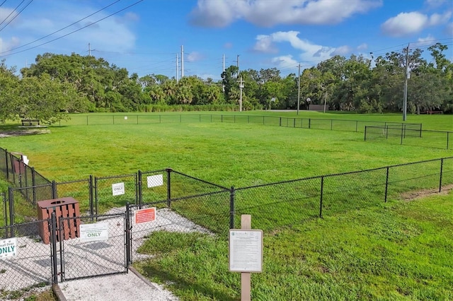4658 Longwater Chase Unit 104, Sarasota, FL 34235 - view of home's community featuring a gate, a dog friendly area, a view of countryside, and view of wooded area