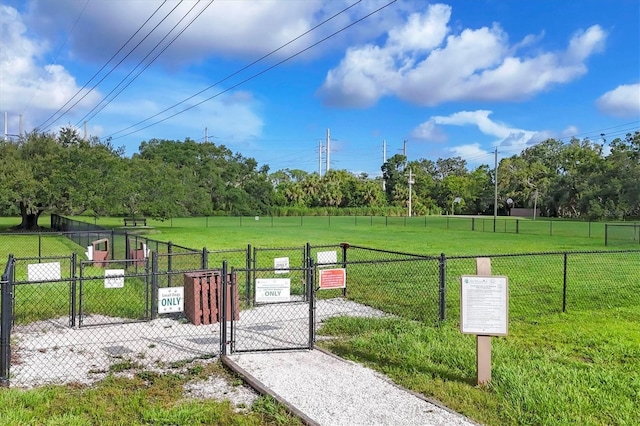 4658 Longwater Chase Unit 104, Sarasota, FL 34235 - surrounding community featuring a dog friendly area, a gate, and view of wooded area