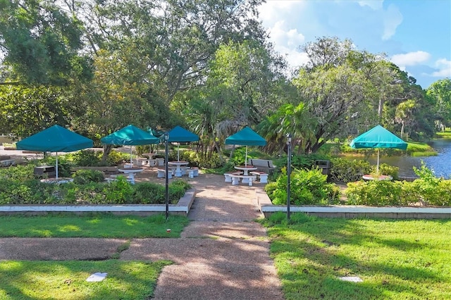 4658 Longwater Chase Unit 104, Sarasota, FL 34235 - view of community with a water view and a lawn