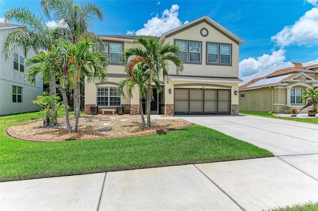 3911 91st Ave E, Parrish, FL 34219 - view of front of house featuring stucco siding, concrete driveway, an attached garage, and a front lawn