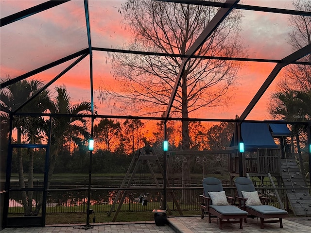 3911 91st Ave E, Parrish, FL 34219 - view of patio / terrace featuring a playground and glass enclosure