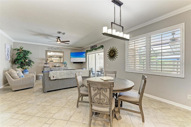 3911 91st Ave E, Parrish, FL 34219 - dining area featuring crown molding, healthy amount of natural light, a ceiling fan, and light stone finish floors