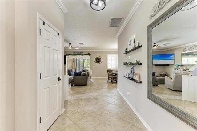 3911 91st Ave E, Parrish, FL 34219 - corridor with ornamental molding, stone tile floors, a textured ceiling, and healthy amount of natural light