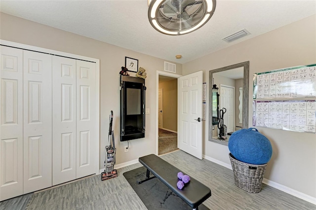 3911 91st Ave E, Parrish, FL 34219 - exercise room featuring wood finished floors and baseboards