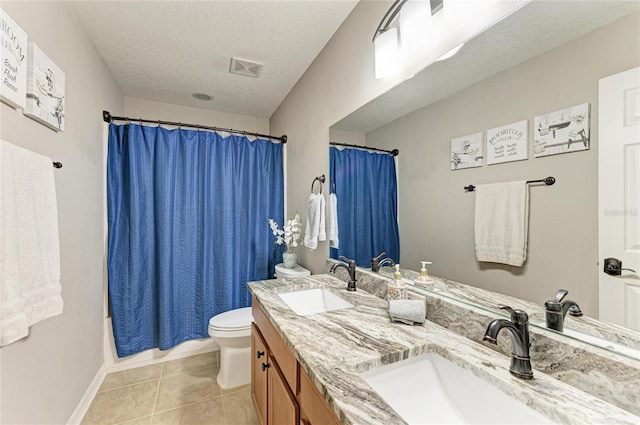 3911 91st Ave E, Parrish, FL 34219 - bathroom featuring double vanity, a textured ceiling, tile patterned floors, and shower / bath combination with curtain