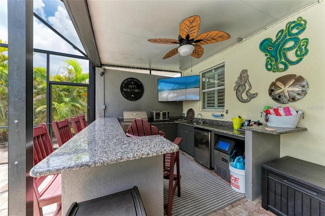 3911 91st Ave E, Parrish, FL 34219 - view of patio / terrace featuring a ceiling fan and exterior kitchen