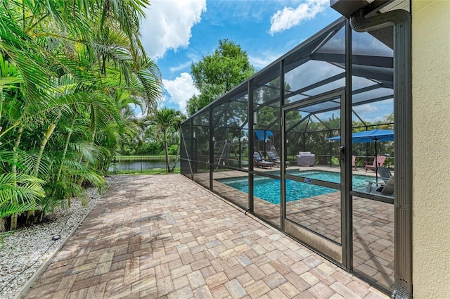 3911 91st Ave E, Parrish, FL 34219 - outdoor pool featuring a patio area, a lanai, and a water view