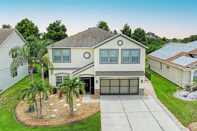 3911 91st Ave E, Parrish, FL 34219 - view of front of house featuring stucco siding, stone siding, an attached garage, and concrete driveway