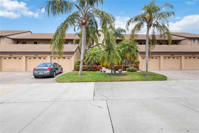 5705 Ashton Way Unit 5705, Sarasota, FL 34231 - view of front facade with community garages, stucco siding, and a tiled roof
