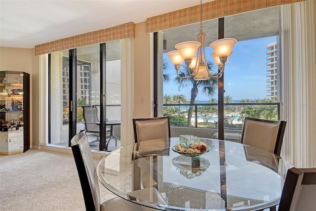 1211 Gulf Of Mexico Dr Unit 105, Longboat Key, FL 34228 - carpeted dining room with a chandelier