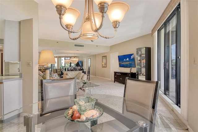 1211 Gulf Of Mexico Dr Unit 105, Longboat Key, FL 34228 - living area featuring a chandelier and baseboards