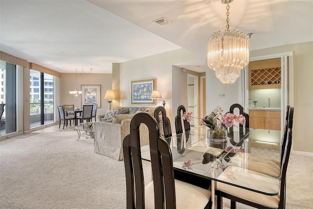 1211 Gulf Of Mexico Dr Unit 105, Longboat Key, FL 34228 - carpeted dining space featuring a chandelier and a sink