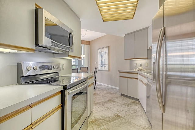 1211 Gulf Of Mexico Dr Unit 105, Longboat Key, FL 34228 - kitchen with appliances with stainless steel finishes and light countertops