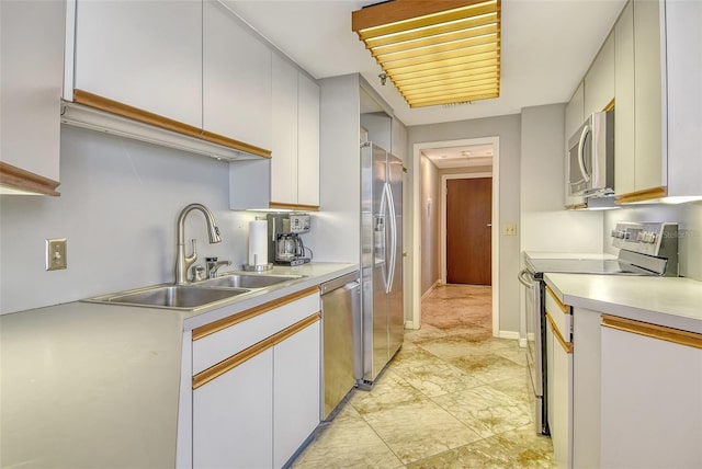 1211 Gulf Of Mexico Dr Unit 105, Longboat Key, FL 34228 - kitchen featuring appliances with stainless steel finishes, light countertops, and white cabinetry