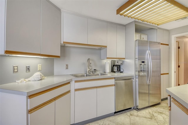 1211 Gulf Of Mexico Dr Unit 105, Longboat Key, FL 34228 - kitchen with stainless steel appliances, light countertops, light marble finish flooring, and white cabinets