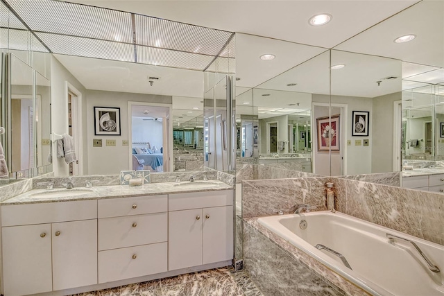 1211 Gulf Of Mexico Dr Unit 105, Longboat Key, FL 34228 - bathroom with a garden tub, double vanity, connected bathroom, marble finish flooring, and recessed lighting